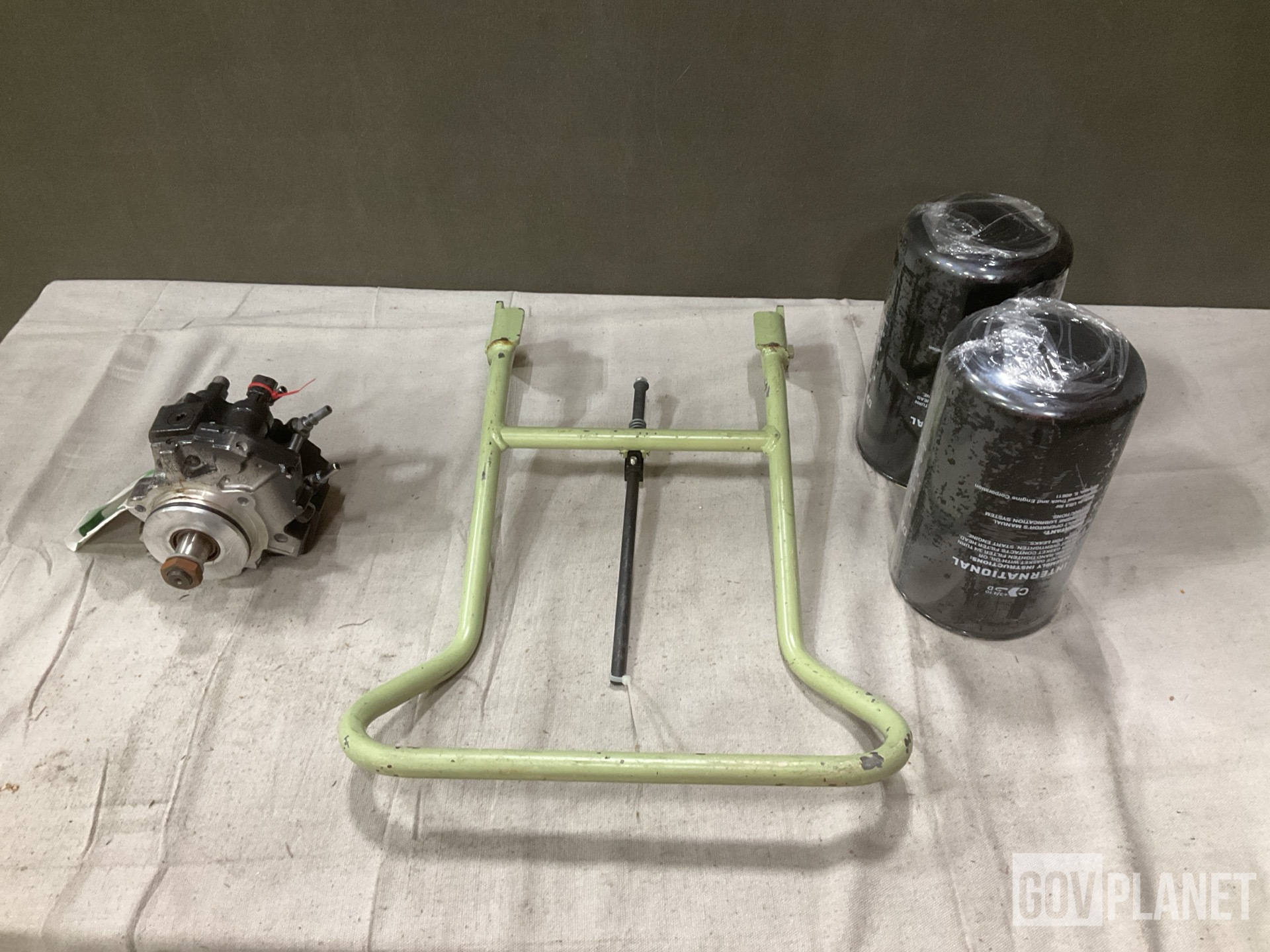 (1) Footrest, (1) Fuel Metering Pump & (18) Oil Filters & Assorted Items